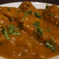 Chicken Curry · Chicken with mild spices, lemon juices and tomato paste. Comes with a side of basmati rice o...