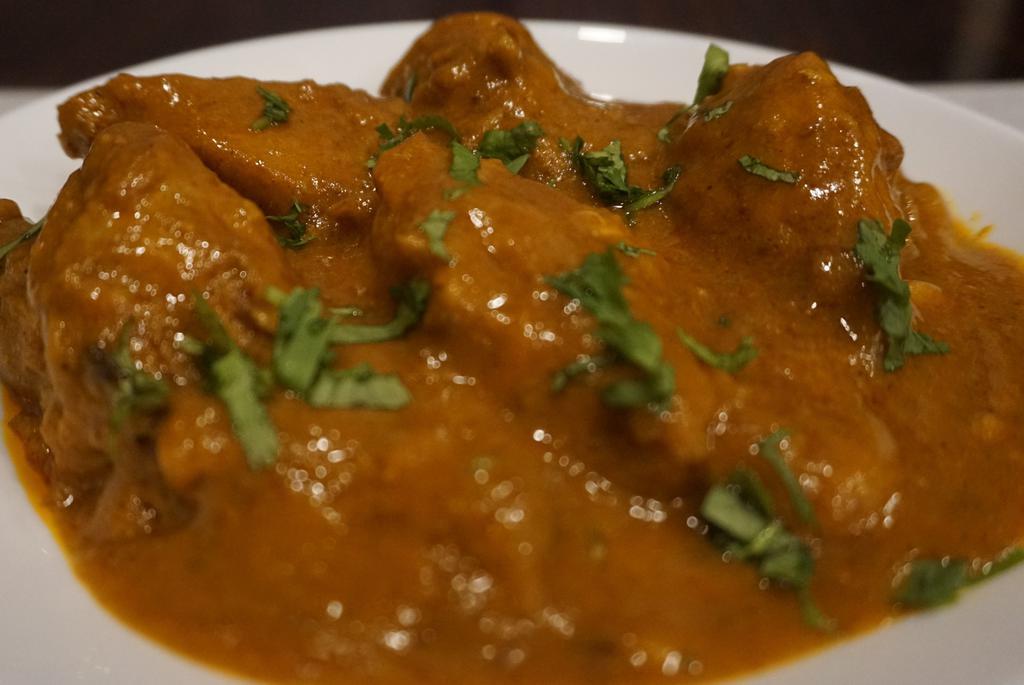 Chicken Curry · Chicken with mild spices, lemon juices and tomato paste. Comes with a side of basmati rice or naan.