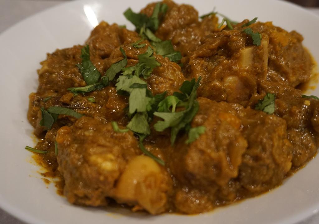 Goat Curry · Goat cooked with tomato, onion, thyme, garlic and Indian curry spices.
