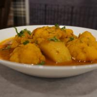 Aloo Gobhi · Cauliflower and potato cooked with tomato, onion and spices. Comes with rice or naan.