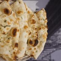 Garlic Naan · Naan garnished with freshly chopped garlic, cilantro, olive oil and baked in tandoor.