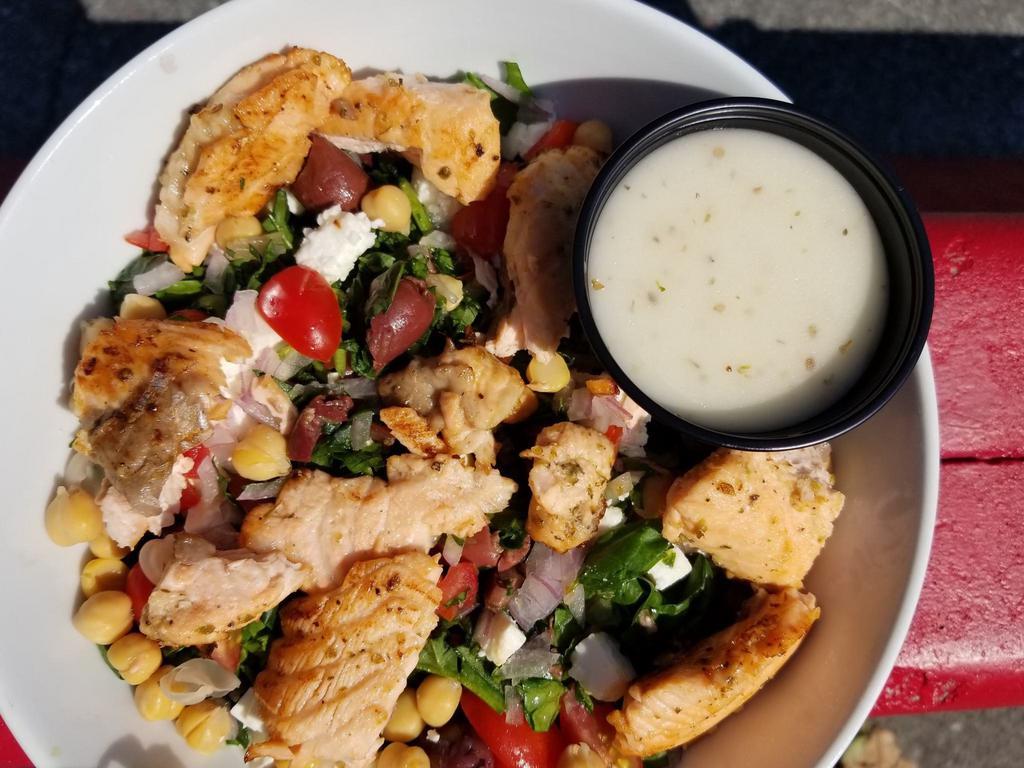   Sautéed salmon over spinach  · Spinach,cherry tomato,cucumber,red onions,feta cheese,olives,chickpeas,chopped,oregano dressing.