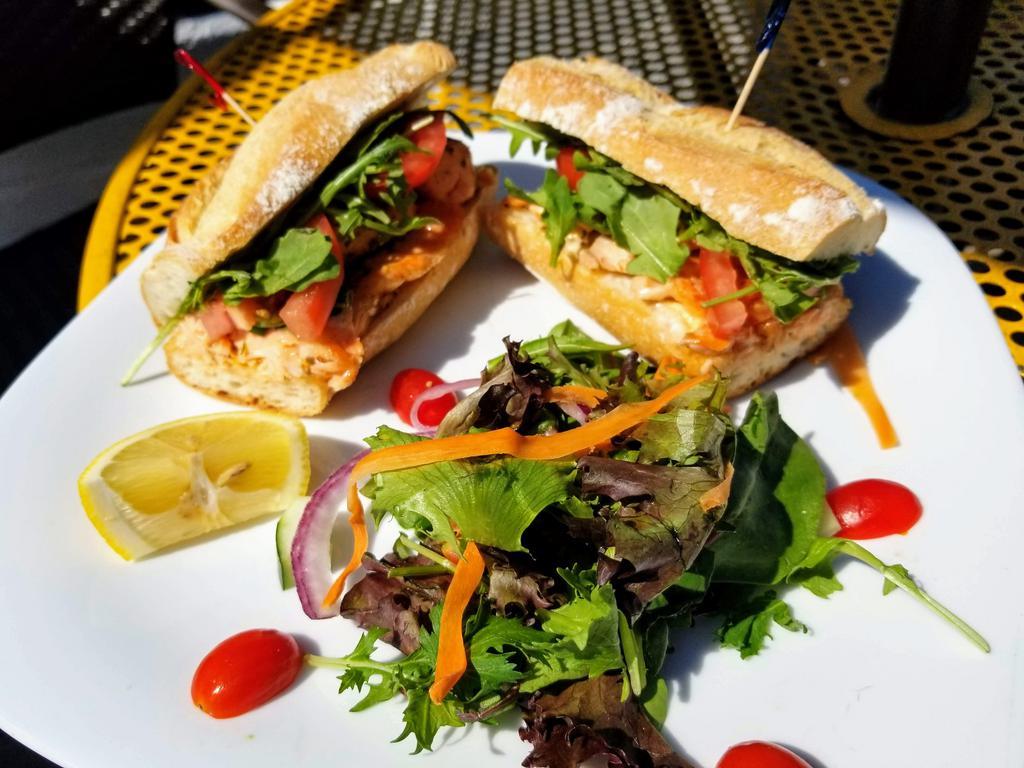 Salmon sandwich on Baguette ·  Salmon,spicy truffle mayo,Arugula,tomato 
