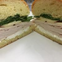 Turkey and Goat Cheese Sandwich · With apple, arugula and honey Dijon. Served with our famous homemade potato chips.
