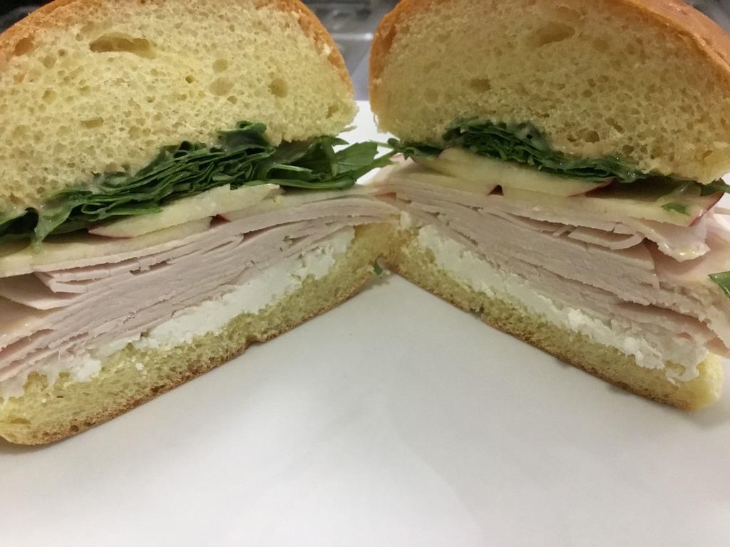 Turkey and Goat Cheese Sandwich · With apple, arugula and honey Dijon. Served with our famous homemade potato chips.