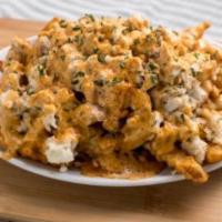 Spicy Crab Fries · Lump crab meat drizzled with American cheese sauce and chipotle aioli.