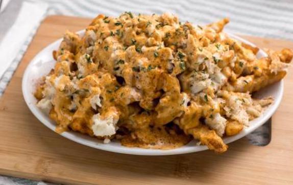 Spicy Crab Fries · Lump crab meat drizzled with American cheese sauce and chipotle aioli.