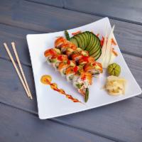Ocean Roll · Shrimp tempura, avocado on top with salmon, seaweed salad, red tobiko and eel sauce.