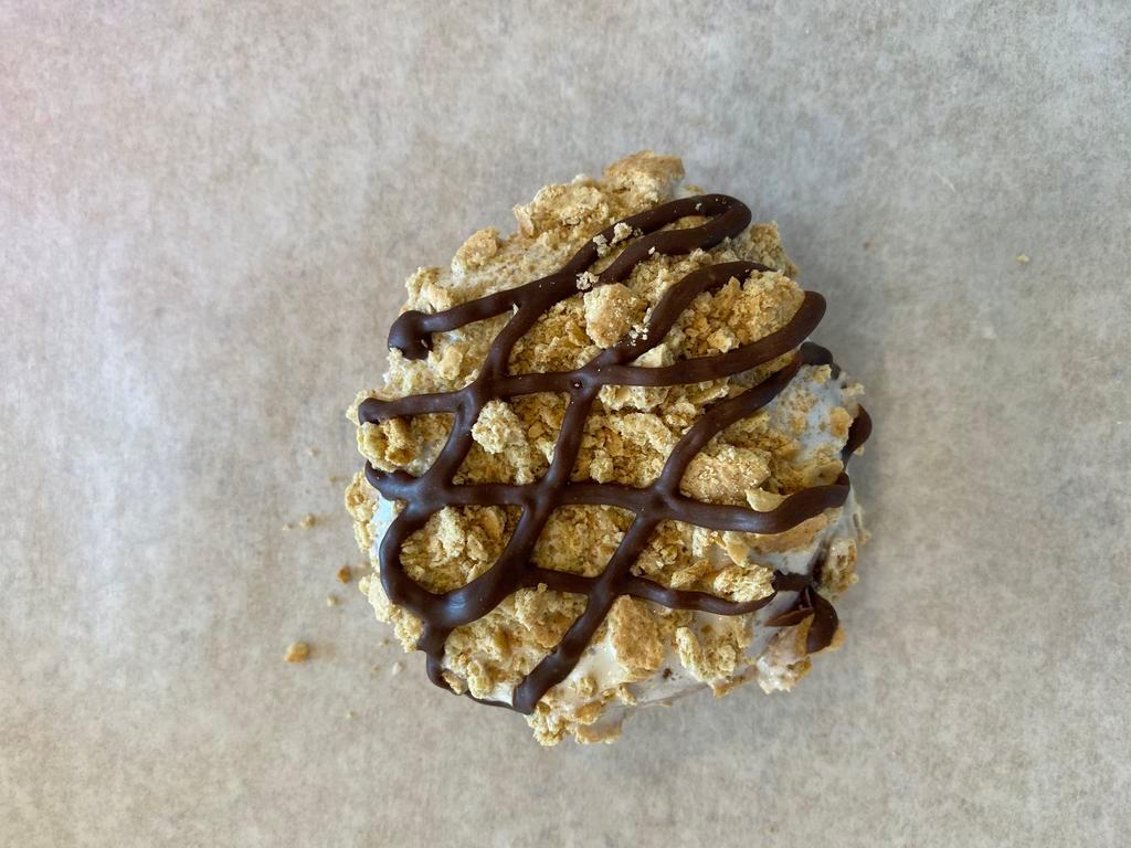 S'mores Donut · Raised donut dipped in marshmallow frosting and topped with graham cracker crumbles and drizzled in chocolate