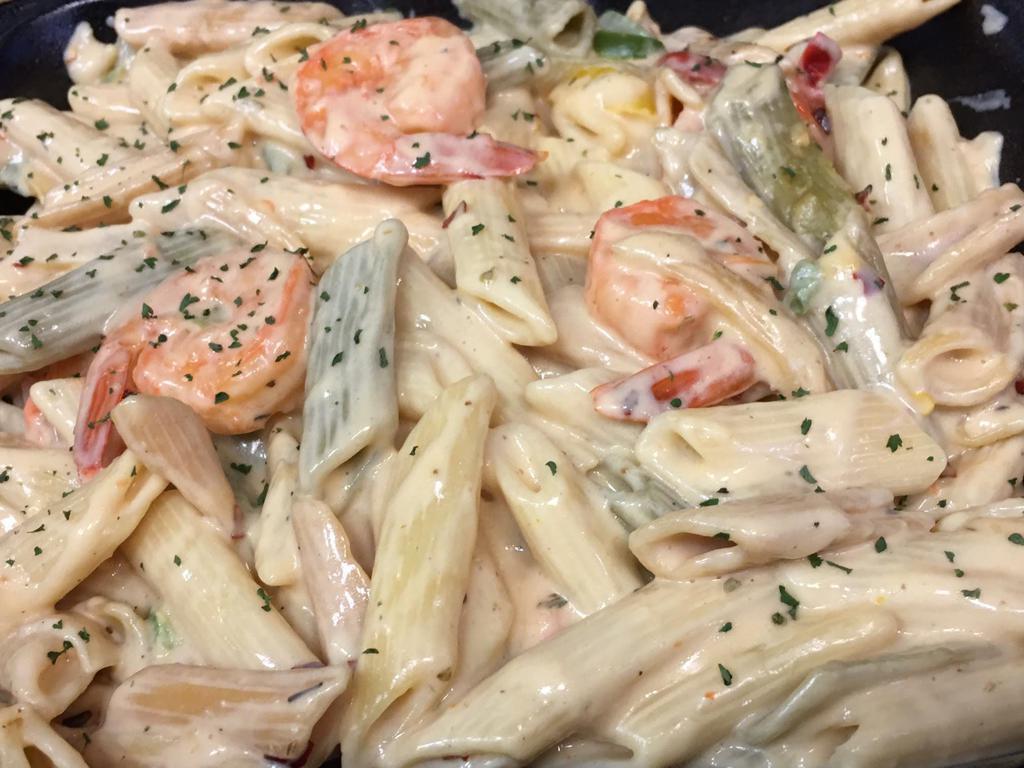 Shrimp Rasta Pasta · Caribbean style 10 pieces shrimp and pasta engulfed in a rich creamy spiced Alfredo sauce. Extras for an additional charge.