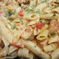 Salmon Rasta Pasta · Caribbean style filleted salmon and pasta engulfed in a rich creamy spiced Alfredo sauce. Ex...