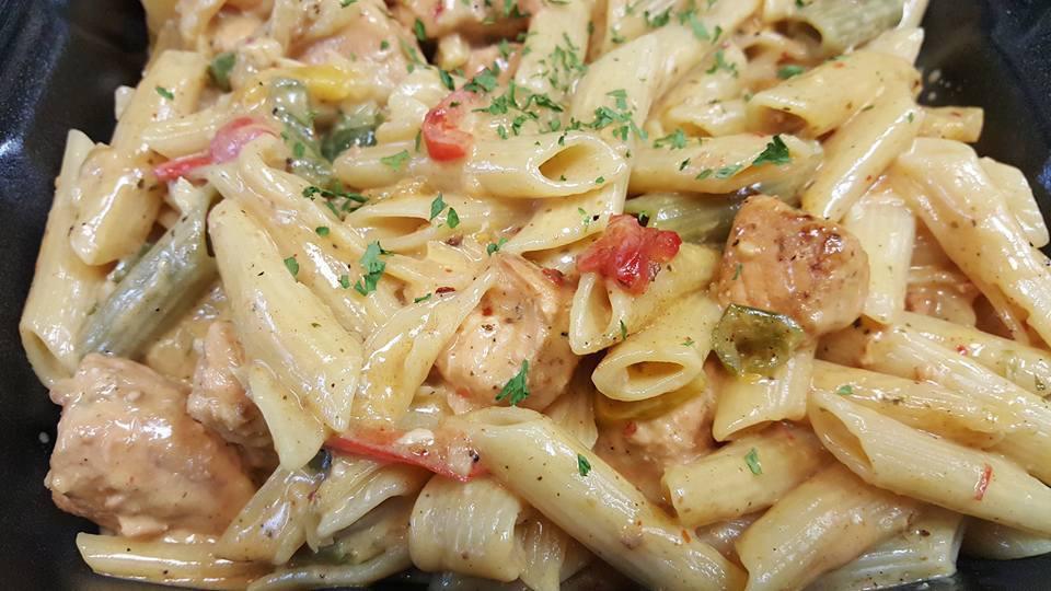 Salmon Rasta Pasta · Caribbean style filleted salmon and pasta engulfed in a rich creamy spiced Alfredo sauce. Extras for an additional charge.