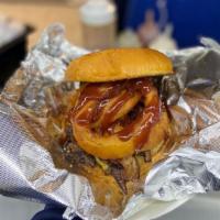 Western Burger · Patty, double American cheese, bacon, onion rings, grilled onions, BBQ sauce.