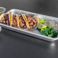 Beef Tacos · Corn tortilla, asada meat, grilled onions, cilantro, jalapeno toreado, limes.