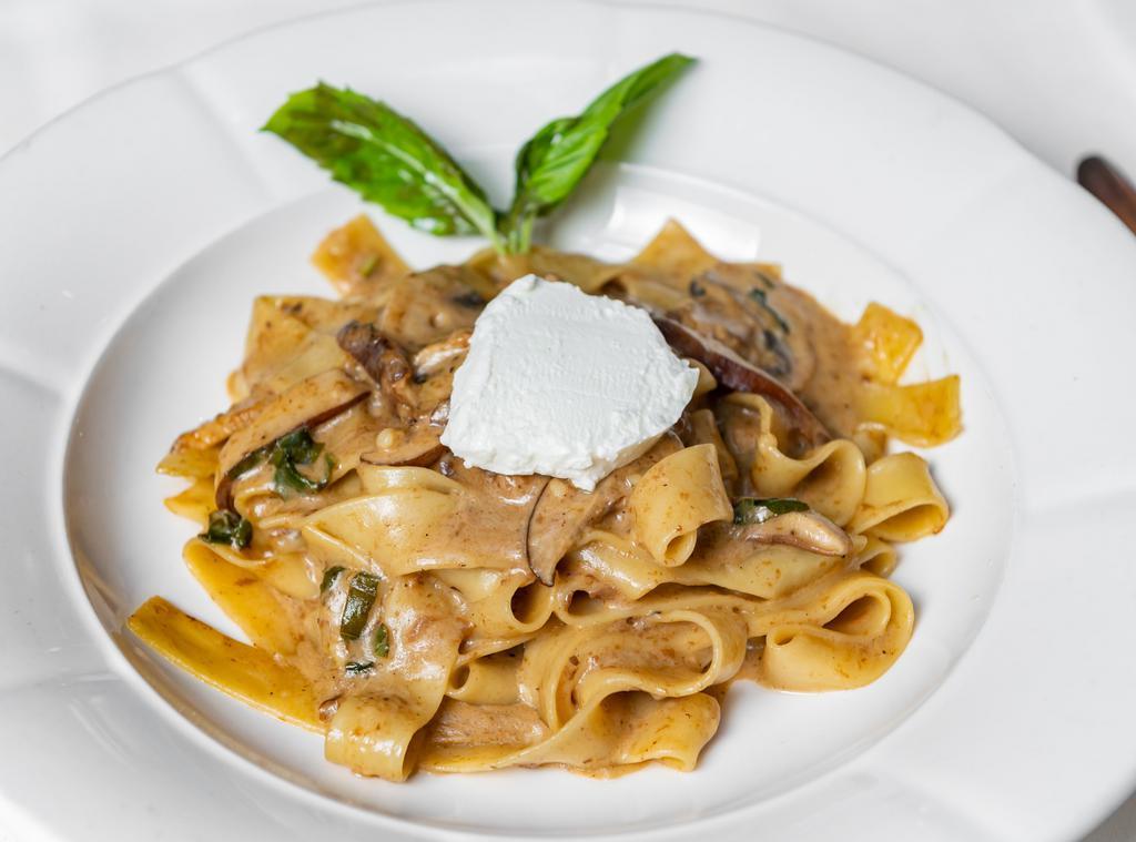 Pappardelle con Funghi · Homemade pasta, wild mushroom ragu, truffle oil and goat cheese.