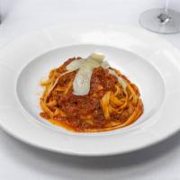 Fettuccine con Ragu · Homemade pasta, tomato and Tuscan lamb ragu.