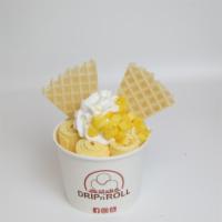 Mango Passion Ice Cream Roll · Mango ice cream, topped with whipped cream, waffle pieces, mango cubes, and mango drizzle.