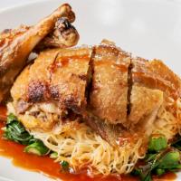 Royal Duck · Roasted crispy duck with brown gravy sauce, served with Thai style egg noodles and Thai broc...