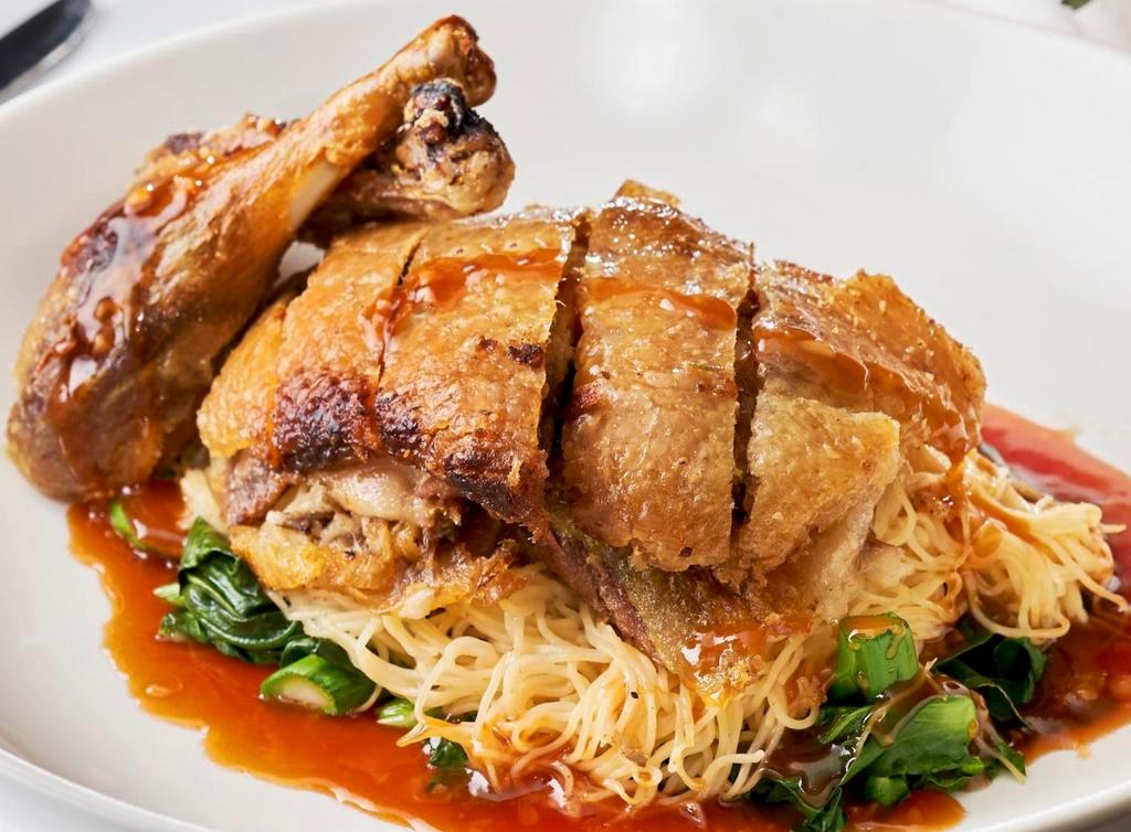 Royal Duck · Roasted crispy duck with brown gravy sauce, served with Thai style egg noodles and Thai broccoli.
