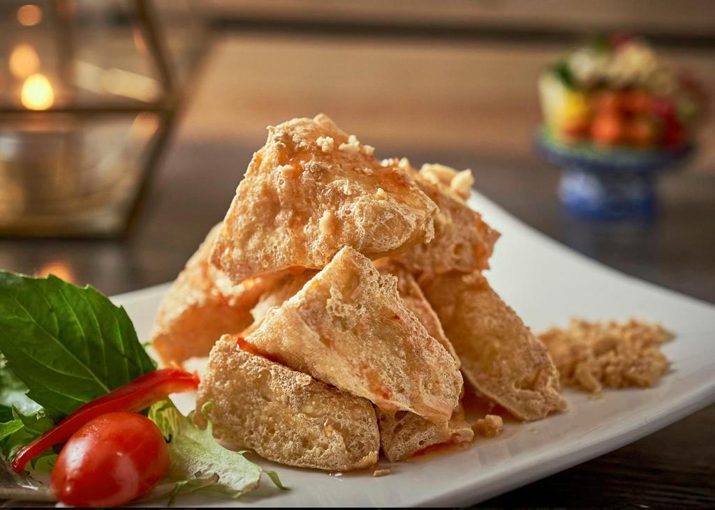 Triangle Bean Curds · Crispy tofu served with a spicy peanut and tamarind sauce.