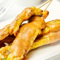 Chicken Satay · Grilled marinated chicken in curry barbecued sauce, served with peanut sauce and traditional...