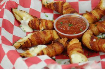 Bacon Wrapped Mozzarella Sticks · Thick-cut bacon spiraled around 4 wonton-wrapped mozzarella sticks and then fried. Sliced and served with tangy marinara sauce.
