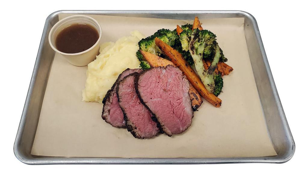 Tri Tip Dinner Plate · Wood-Fired Tri Tip, Garlic Herb Butter, Yukon Gold Mashed Potatoes, Charred Broccoli & Carrots, Au Jus Sauce (on the side).