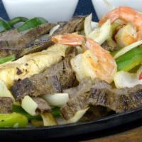 Parrillada Mixta · Grilled chicken breast, beef, fajita, and shrimps with onions, green and red bell peppers, c...