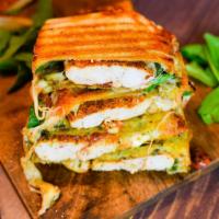 P1. Chicken Melt Panini · Spinach chicken, grilled onions, Swiss cheese, peppers, avocado, and romaine lettuce.
