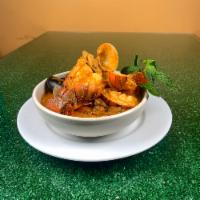 Casuela de Mariscos/ seafood in creole sauce · 1 choose : arroz y habichuelas, tostones , maduros, papas fritas, pure de papas, moro de gan...
