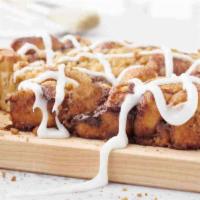 Cinnamon Pull Apart · Bite-sized sweet roll dough covered in cinnamon and crumbles, then baked and drizzled with c...