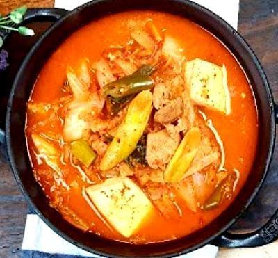 김찌찌개 (Spicy Kimchi Stew with Pork) · Spicy. pork belly in, rice and side dishes are followed