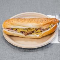 8. Cubano Tozt · Roasted pork, sliced ham, Swiss cheese, pickle and mustard.