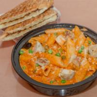 Penna Alla Vodka · With grilled chicken and sweet peas topped with Parmesan cheese. Served with garlic bread.