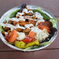 Chicken Tikka Shawarma Salad Bowl · Served on a bed of spring mix with hummus, our signature tzatziki and spicy sauce.