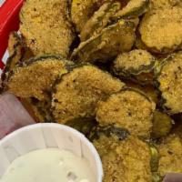 Fried Dill Pickles · A heap of pickle slices fried in our own special breading.