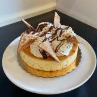 Cannoli Cheesecake · Our creamy New York style cheesecake topped with cannoli cream and cannoli shells with a cho...