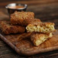 Classic Mac & Cheese bites · Fried macroni and cheese bites served with house sauce