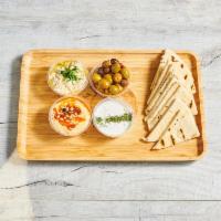 Dip Trio · Hummus, baba ghanoush, tzatziki, marinated olives, served with pita or veggies