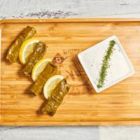 House Made Dolmaddes · Stuffed grape leaves, rice, pine nuts, currants, Mediterranean herbs and spices, tzatziki


