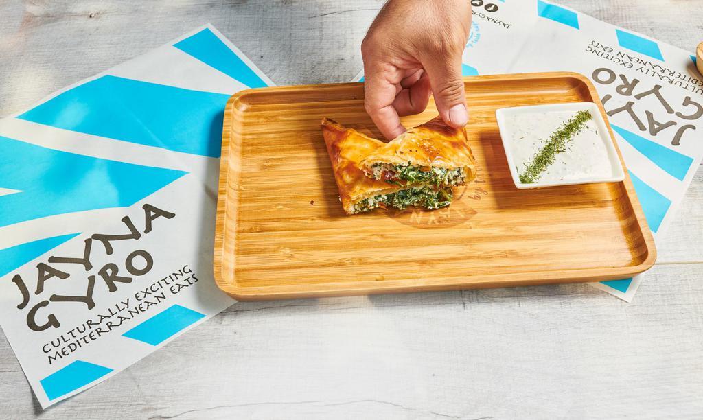 Spanakopita · Phyllo dough stuffed with spinach and feta, served with tzatziki


