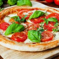Margherita Pizza · Traditional tomato sauce, mozzarella cheese, fresh Roma tomatoes, fresh basil and drizzled w...