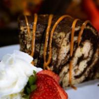 Marble Cake · Chocolate and vanilla cake filled with chocolate fudge. Add ice cream scoop for an additiona...