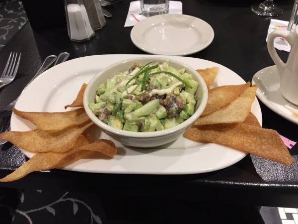 Ahi Tuna Poke · Fresh ahi tossed with cucumber and avocado, with wonton chips, and wasabi dressing.