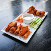 Buffalo Chicken Wings · A dozen wings, Celery sticks and carrots, served with bleu cheese dressing.