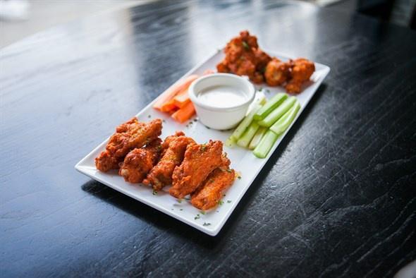 Buffalo Chicken Wings · A dozen wings, Celery sticks and carrots, served with bleu cheese dressing.