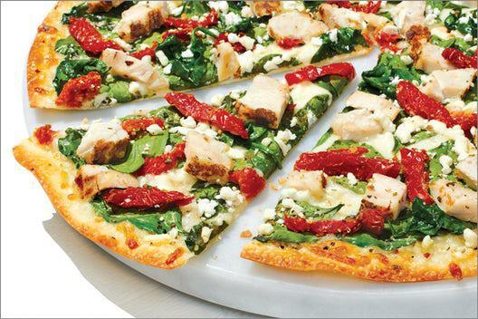 Herb Chicken Mediterranean Pizza · Our artisan thin crust, topped with olive oil, chopped garlic, whole-milk mozzarella, grilled chicken raised without antibiotics, fresh spinach, sun-dried tomatoes, crumbled feta, and zesty herbs.