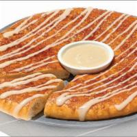 Cinnamon Wheel · Cinnamon spread and oatmeal crisp topping on our original crust served with cream cheese fro...