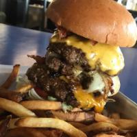 The Monster Burger · 3 1/3 lb. patties topped with bacon, American, Swiss, and cheddar cheese, grilled onions, le...
