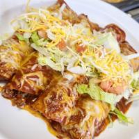 Chipotle Enchiladas · Chicken enchiladas topped with chipotle sauce. Served with rice and beans.